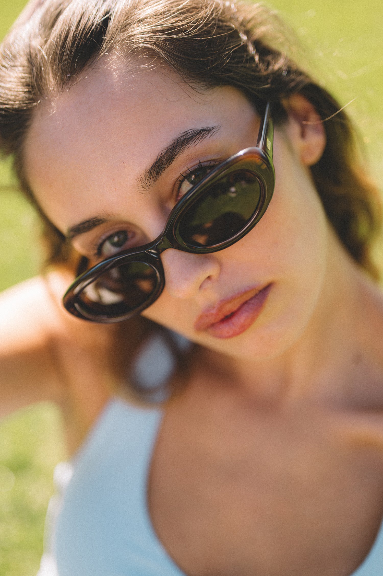 Woman wearing brown oval womens sunglasses